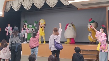 じゃんけん大会で札を出すキャラクターとじゃんけんするお客さん達の写真